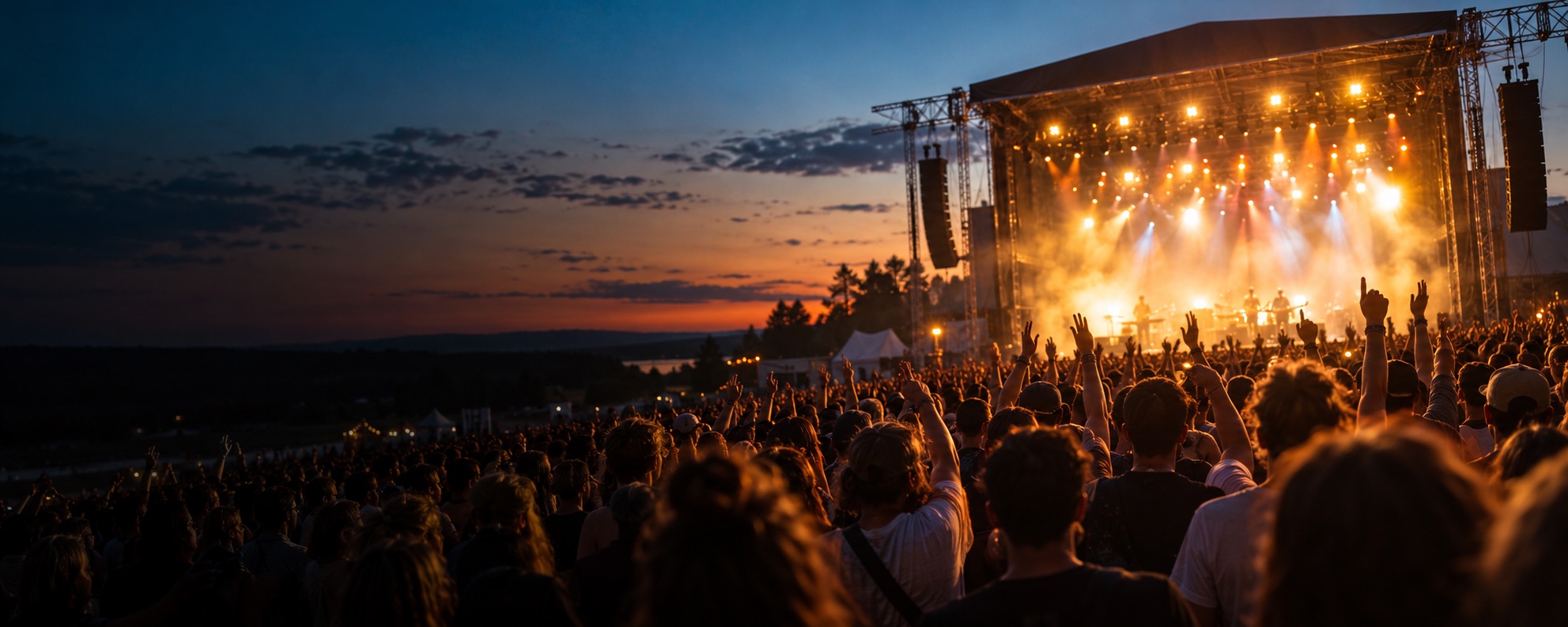 Illustrative image: festival crowd in front of a stage at dusk